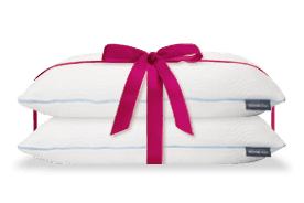 Buy one pillow get one pillow free offer image with red bow tied around two pillows