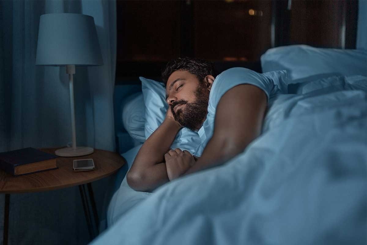 A man sleeping peacefully in a dark room