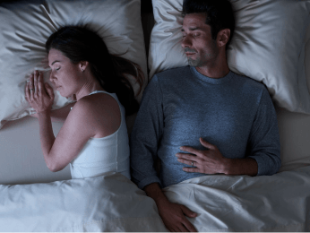 a couple sleeping cool