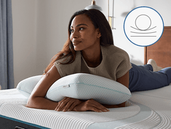 woman laying on tempurpedic comfort pillow with an icon demonstrating a classic shape