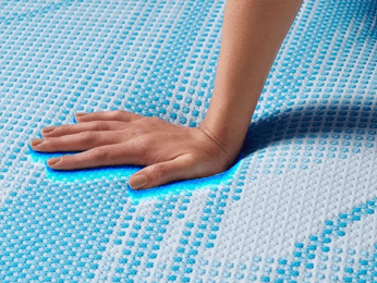 a hand feeling the cooling affects of a Breeze mattress cover