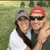 Instagram profile image of lexie_be_cheesin showing woman and man hugging in field of grass while wearing baseball caps and tshirts