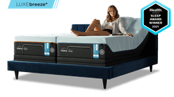 Woman on luxebreeze mattress with health sleep award badge.