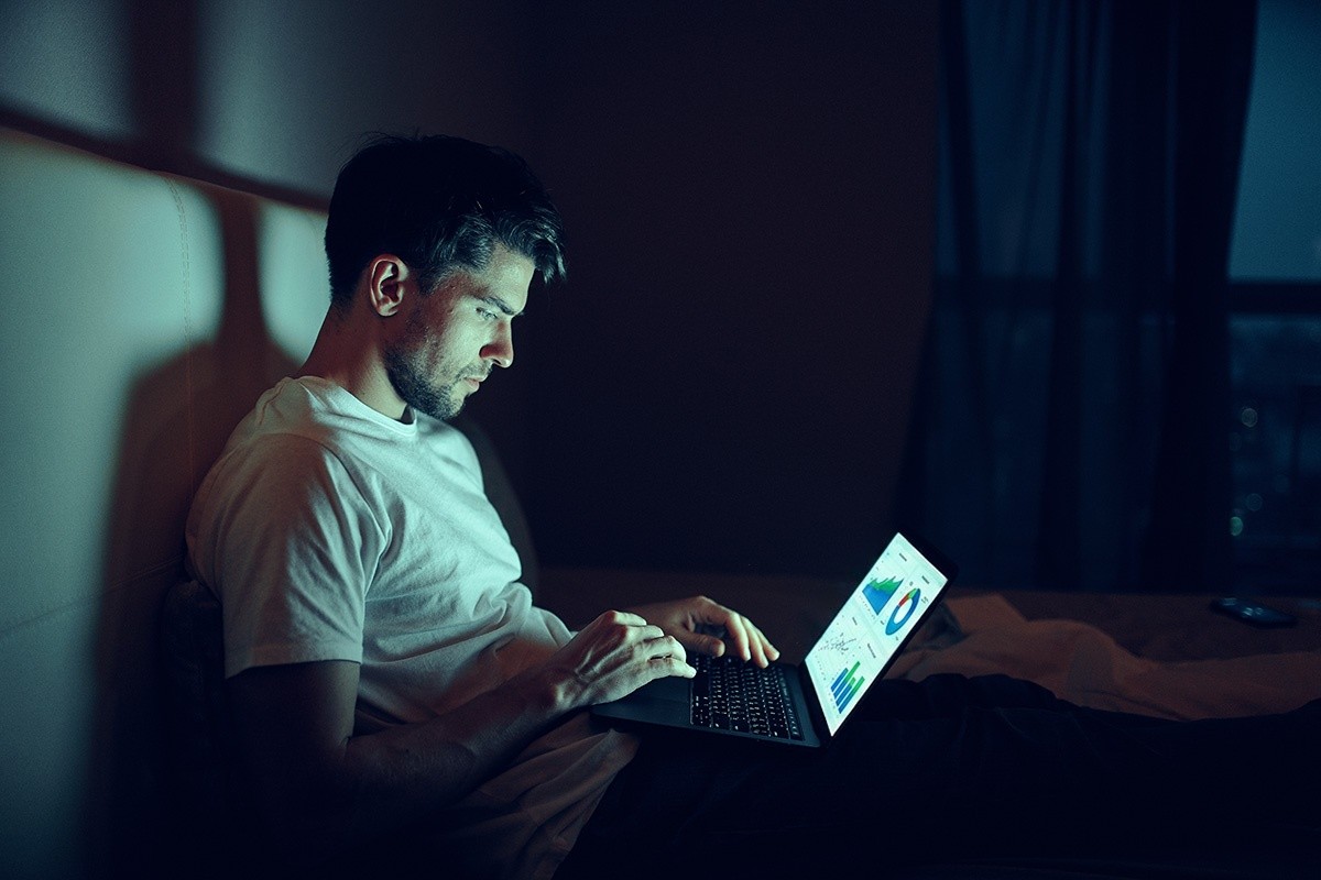 man in bed on his laptop