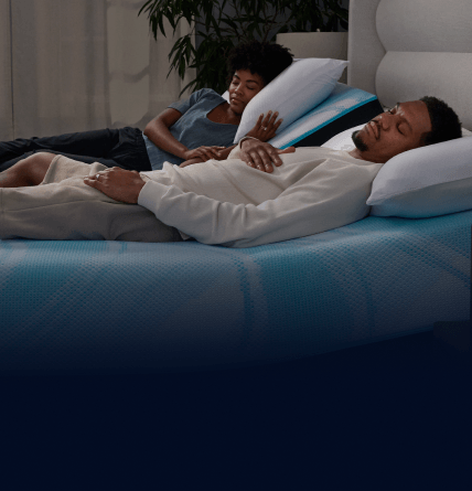 Side view of a man and woman sleeping on a TEMPUR-LuxeBreeze Split Head Mattress going into a fade