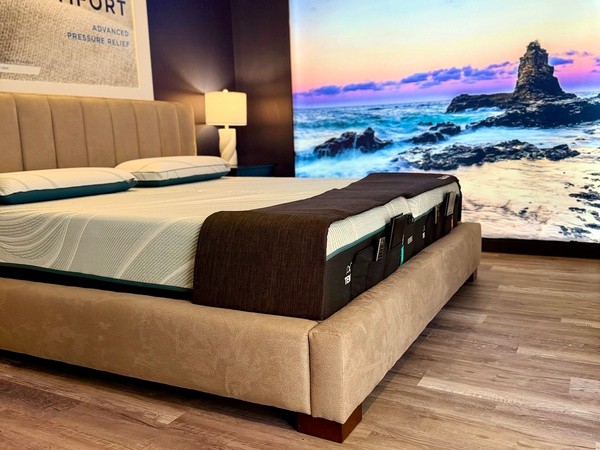 A Tempur-Pedic Retail Showroom Sleep Pod with an Image of a Rocky Sea in the Background