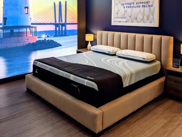 A Tempur-Pedic Retail Showroom Sleep Pod with an Image of a Lighthouse in the Background