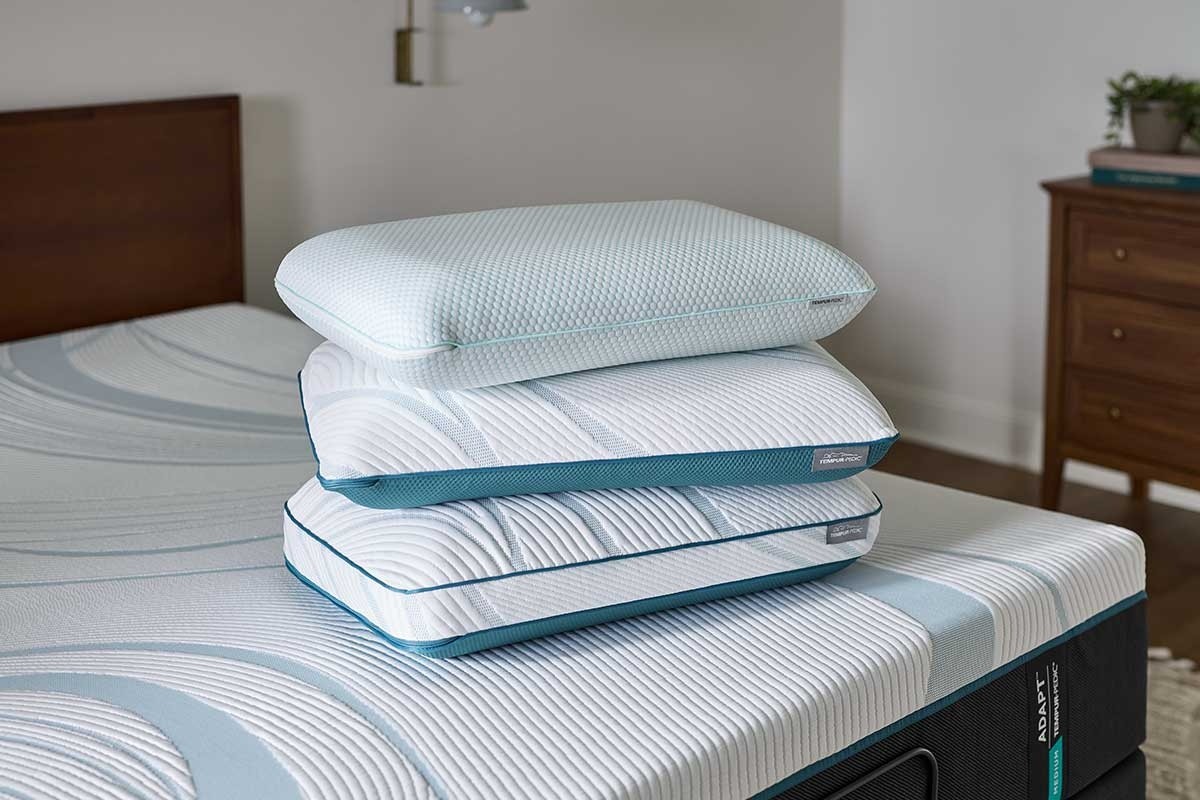 A stack of three Tempur-Pedic pillows on a Tempur-Pedic mattress