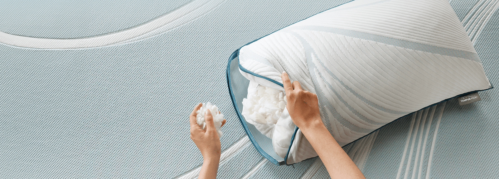Person filling in an Adapt Adjustable pillow