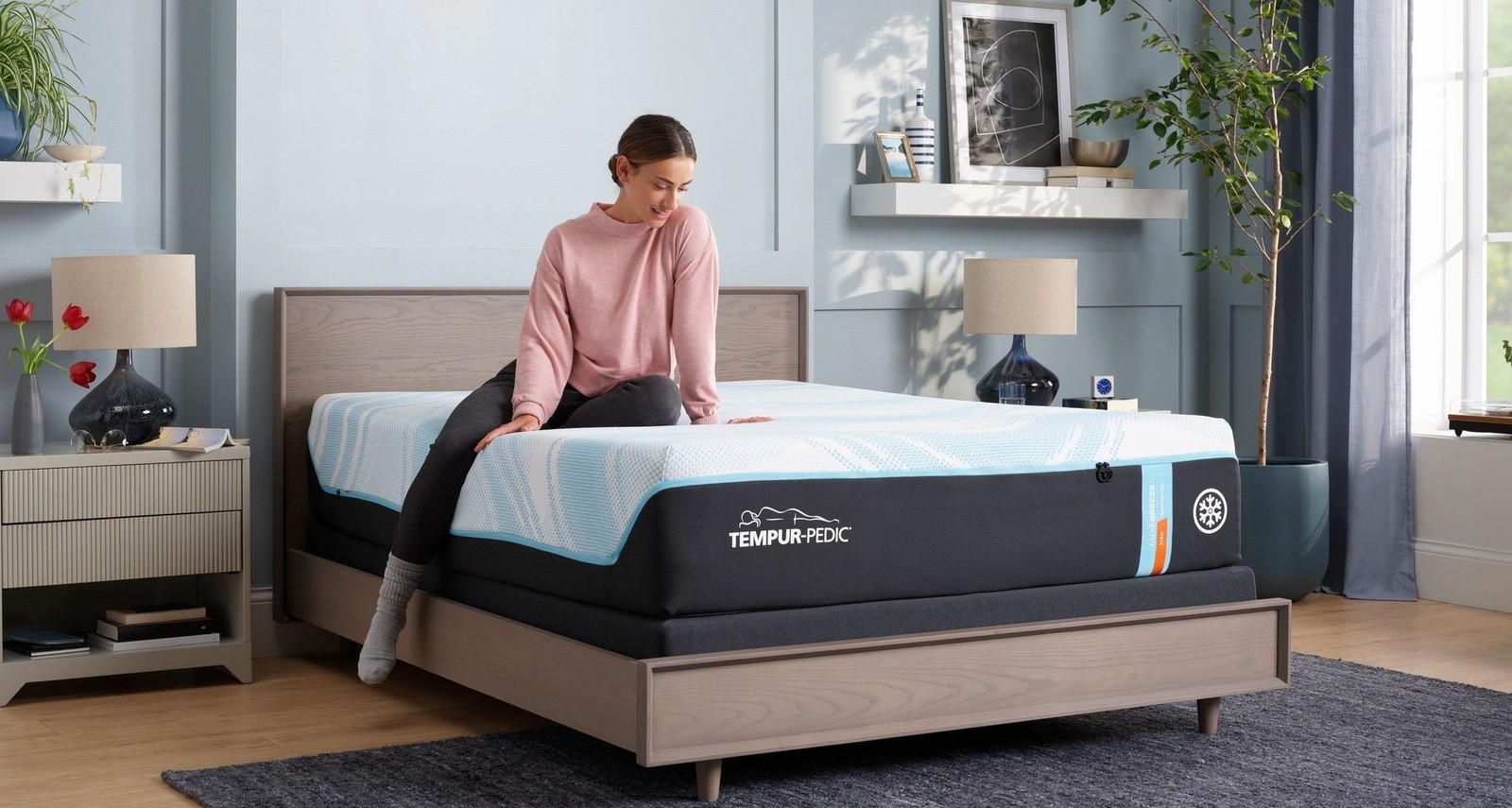 a woman sitting a Breeze® mattress