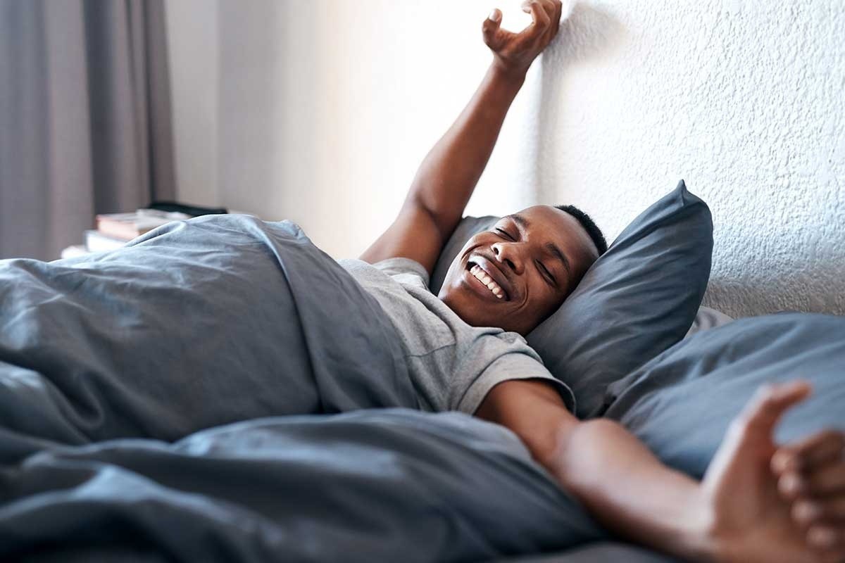 A man waking up refreshed